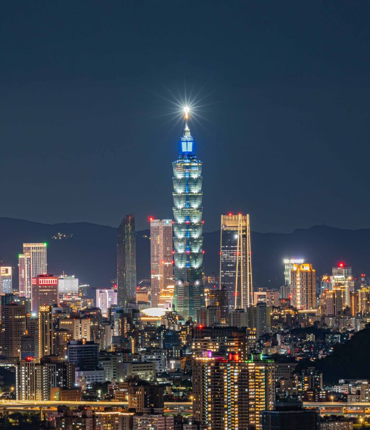 A view of the Taipei skyline at night, with the Taipei 101 building in the middle