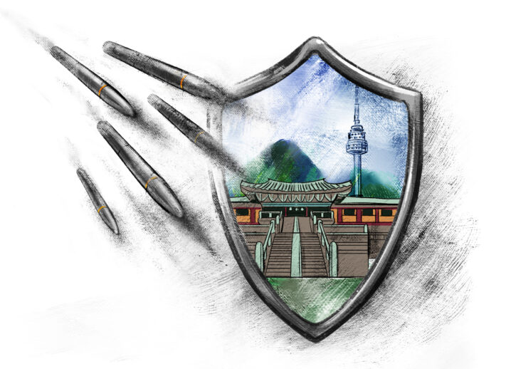 Artwork of an image of South Korea within the outline of a shield. Multiple missiles are fizzling out as they approach the shield.