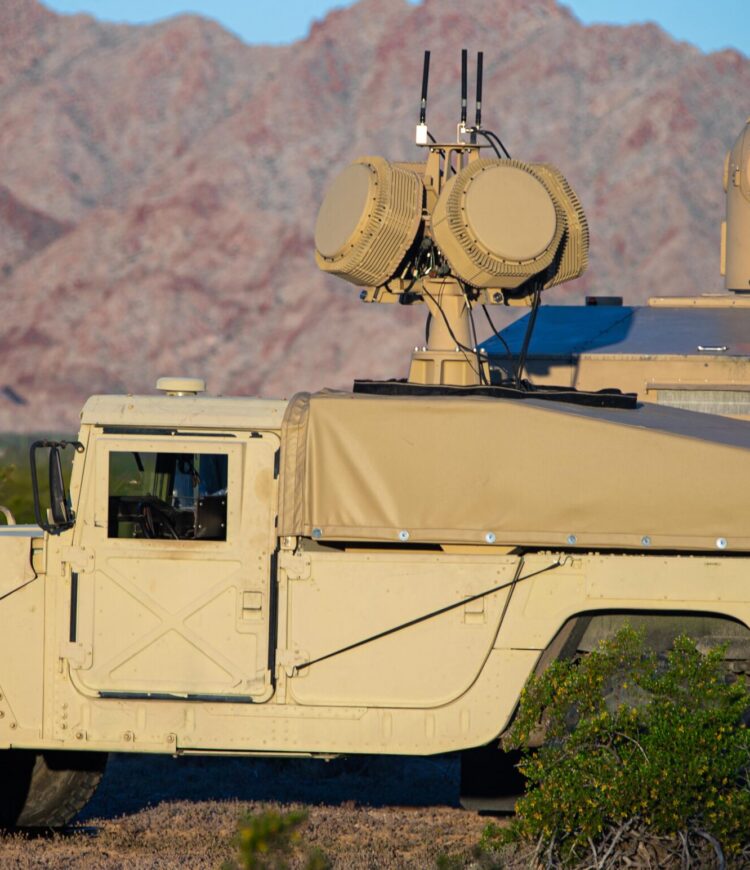 A U.S. Marine Corps High Mobility Multipurpose Wheeled Vehicles with a mounted beam director and radar, assigned to Naval Surface Warfare Center Dahlgren and Crane Division, participate in a high energy laser expeditionary exercise as part of Weapons and Tactics Instructor course 2-24, at Tactical Airfield, near Wellton, Arizona, April 4, 2024. WTI is an advanced graduate-level course that provides advanced tactical training to enhance and employ advanced aviation weapons and tactics. (U.S. Marine Corps photo by Cpl. Alejandro Fernandez)   