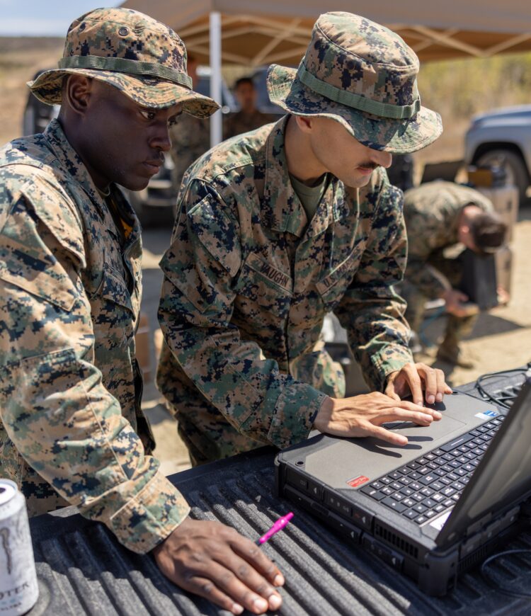 U.S. Marine Corps Lance Cpl. Martin Wuesthoff, left, a surveillance sensor operator with the 11th Marine Expeditionary Unit, I Marine Expeditionary Force, and Cpl. Alex Vaughn, an intelligence specialist with 3rd Battalion, 5th Marine Regiment, 1st Marine Division, I MEF, observe the live feed of an RQ-20 Puma during a Dead Center small unmanned aircraft system training on Marine Corps Base Camp Pendleton, California, Aug. 20, 2025. Dead Center is an artificial intelligence enabled system that enhances sUAS operators’ ability to perform a wide range of surveillance and reconnaissance missions. (U.S. Marine Corps photo by Sgt. Trent A. Henry)