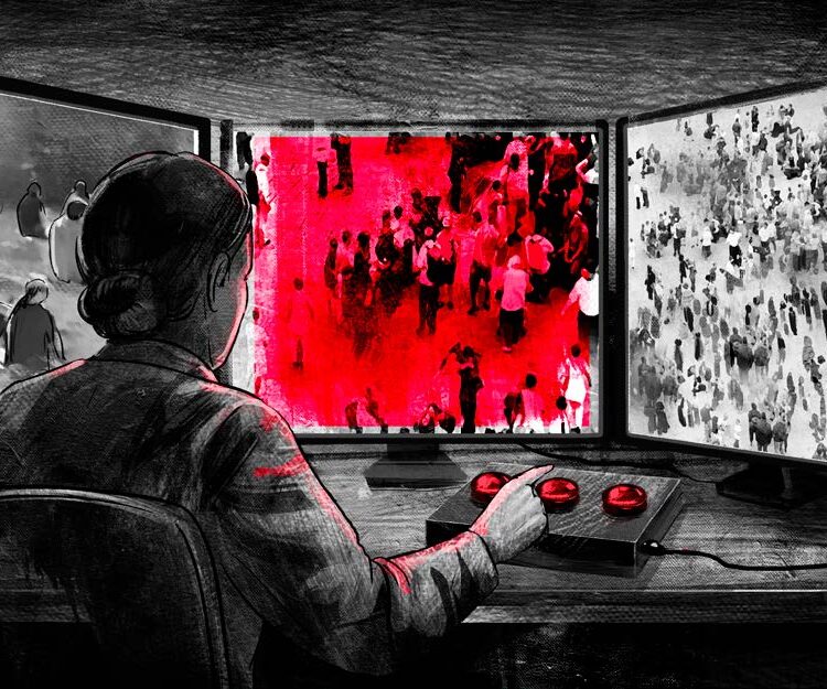 A woman sits in front of three screens, monitoring groups of people. One of the screens is highlighted red.