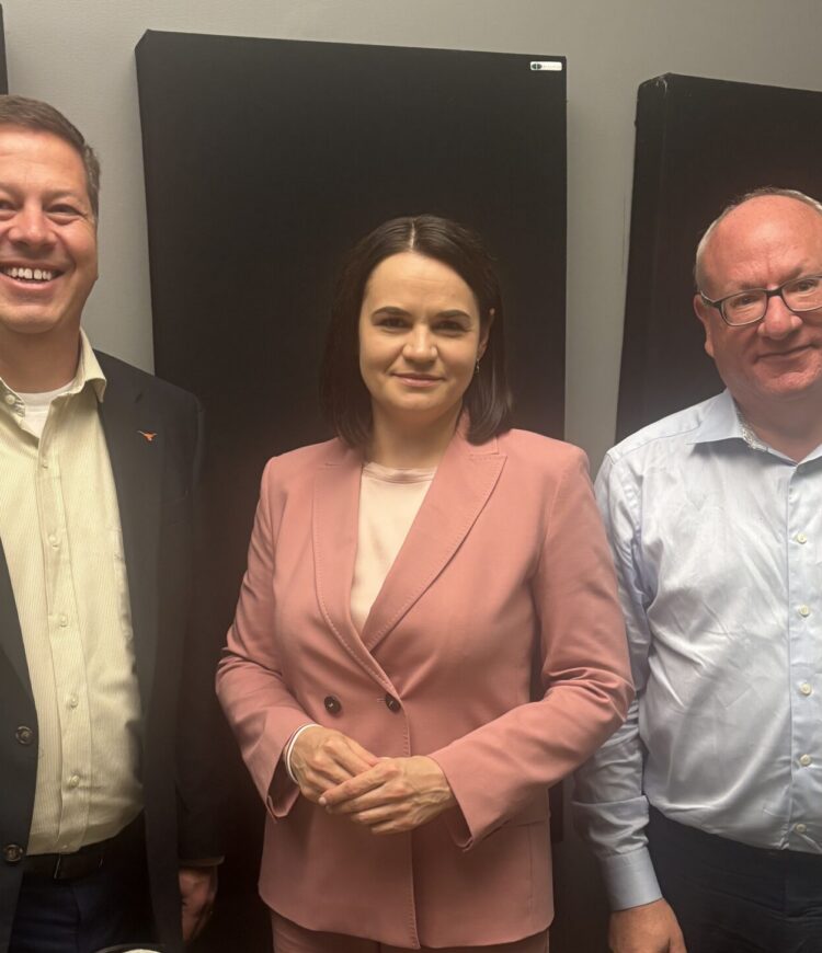 Ryan Vest, Sviatlana Tsikhanouskaya, and Michael Kimmage stand together, smiling